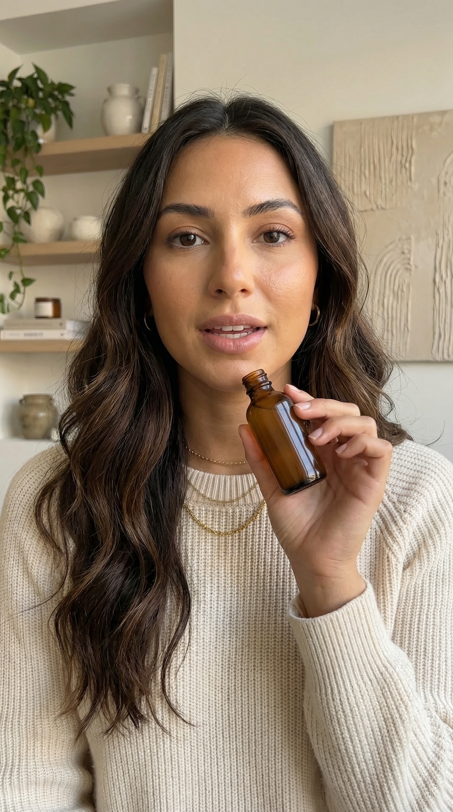 Photoreal vertical source still of a fictional beauty influencer holding an unlabeled serum bottle beside her face in a clean creator-studio setup.